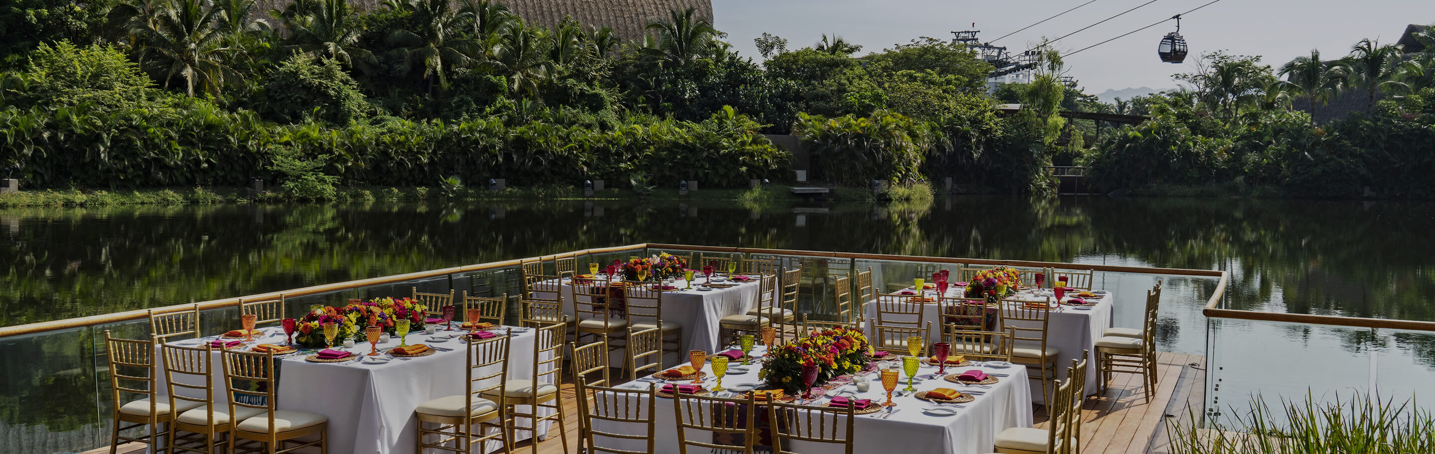 Elegant waterfront event deck at The Grand Bliss Vidanta Nuevo Vallarta, featuring formal dining setup with floral centerpieces—ideal for corporate gatherings, incentive travel, and upscale MICE programs in Mexico.