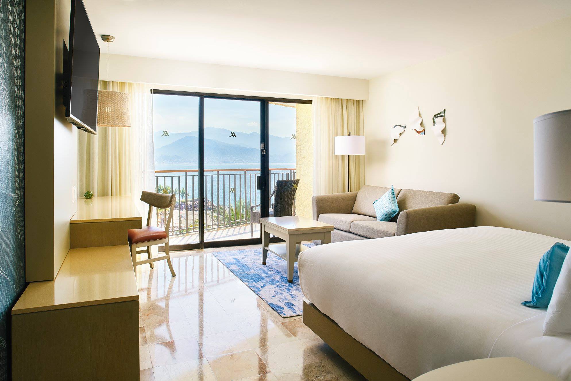 Oceanview suite at Marriott Puerto Vallarta Resort & Spa, featuring modern design, private balcony, and executive comfort—ideal for incentive travel and MICE accommodations in Mexico.