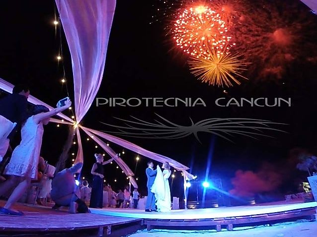 A spectacular display of professional, large-scale white and gold fireworks exploding in the night sky. This high-impact visual is ideal for a grand opening ceremony, corporate gala dinner, major exhibition, or large-scale incentive event, showcasing premium pyrotechnics for MICE events in the Riviera Maya.