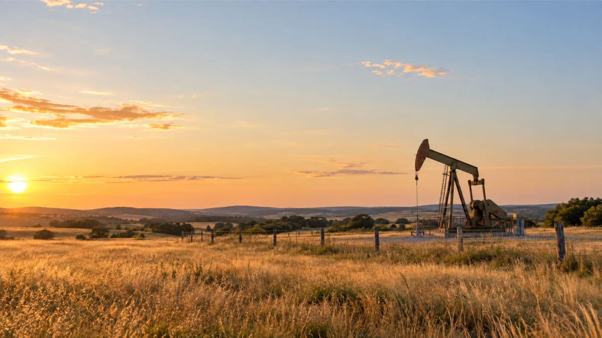 Pumpjack on open Texas ranch land at sunset