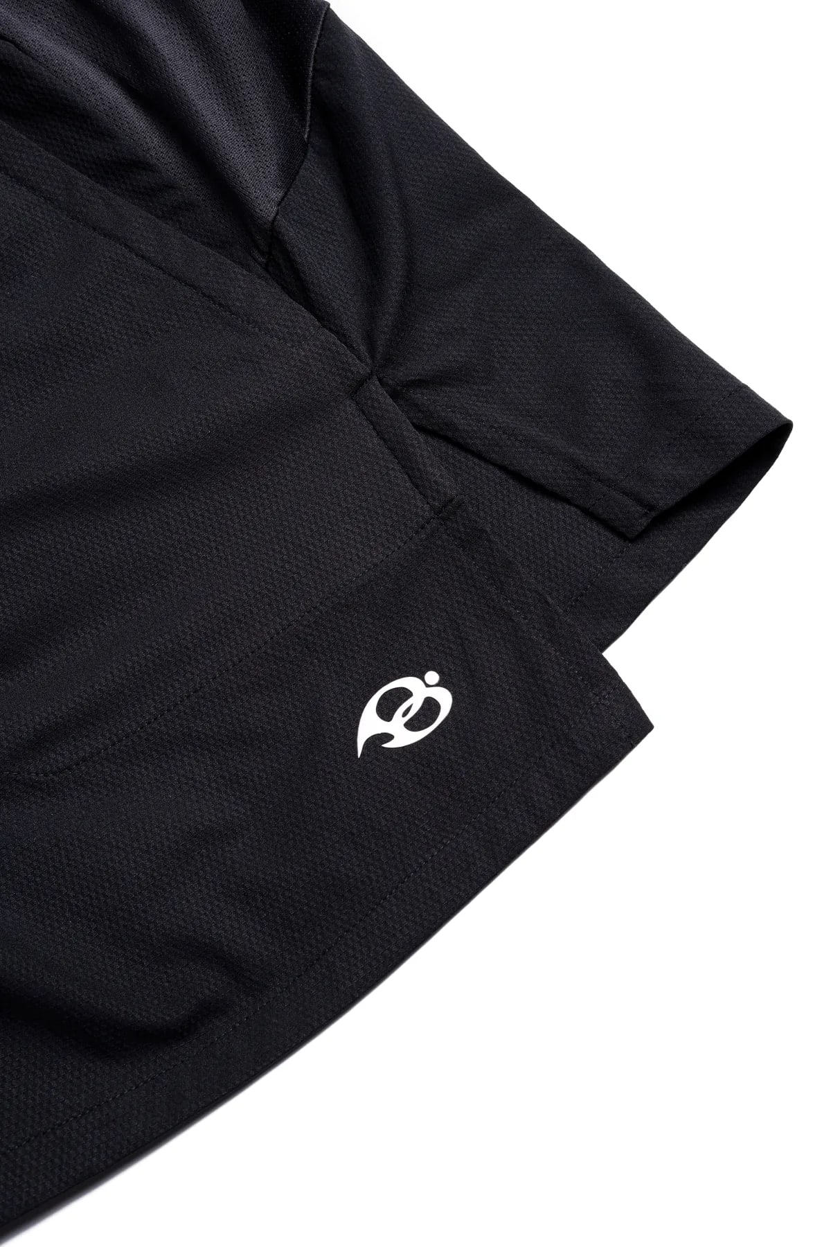 Dark Aura Shorts - the hem and side vent, laid flat