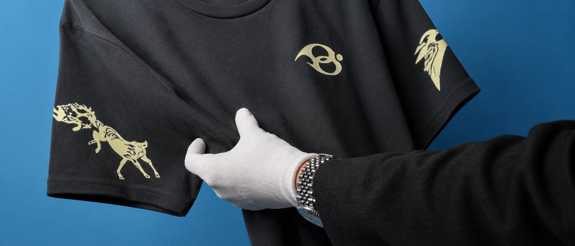 The Wild Strides Tee in Ash on the blue set - the Ghoda chest mark and the horse sleeve print