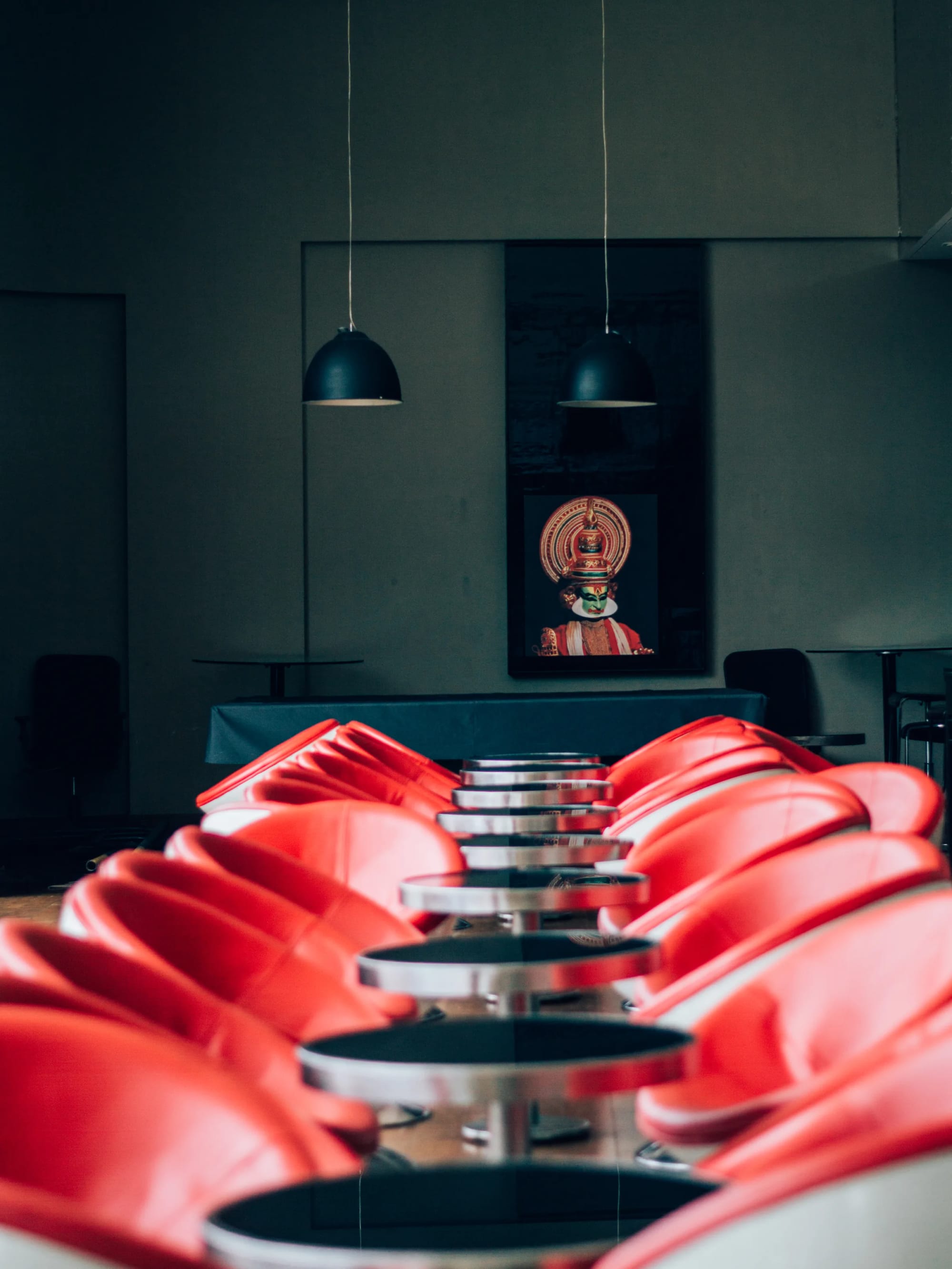 A restaurant interior with red chairs in Kochi