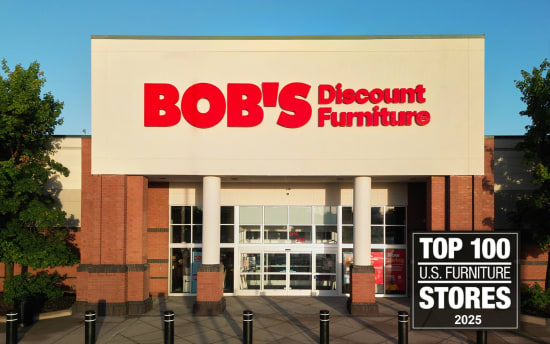 BOB'S Discount Furniture storefront with large red signage on beige facade and a black sign reading "TOP 100 U.S. FURNITURE STORES 2025" on the right side.
