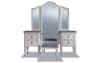 White 4 drawer make-up vanity with bi-fold mirror and gray upholstered vanity stool.