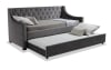 Gray upholstered tufted daybed with pull out trundle bed.