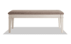 White and beige upholstered storage dining bench.
