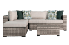 Gray wicker outdoor sectional sofa and ottoman set perfect for a corner spot on a patio.