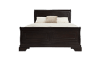Dark brown bed with white bedding and a beige throw pillow that is budget friendly.
