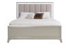 Gray upholstered bed with white bedding and 2 throw pillows