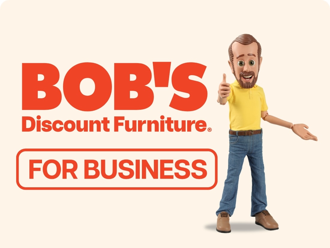 BOB'S Discount Furniture logo with a cartoon man in a yellow shirt and jeans giving a thumbs-up, text "FOR BUSINESS" in a red outlined box, promoting business furniture discounts.