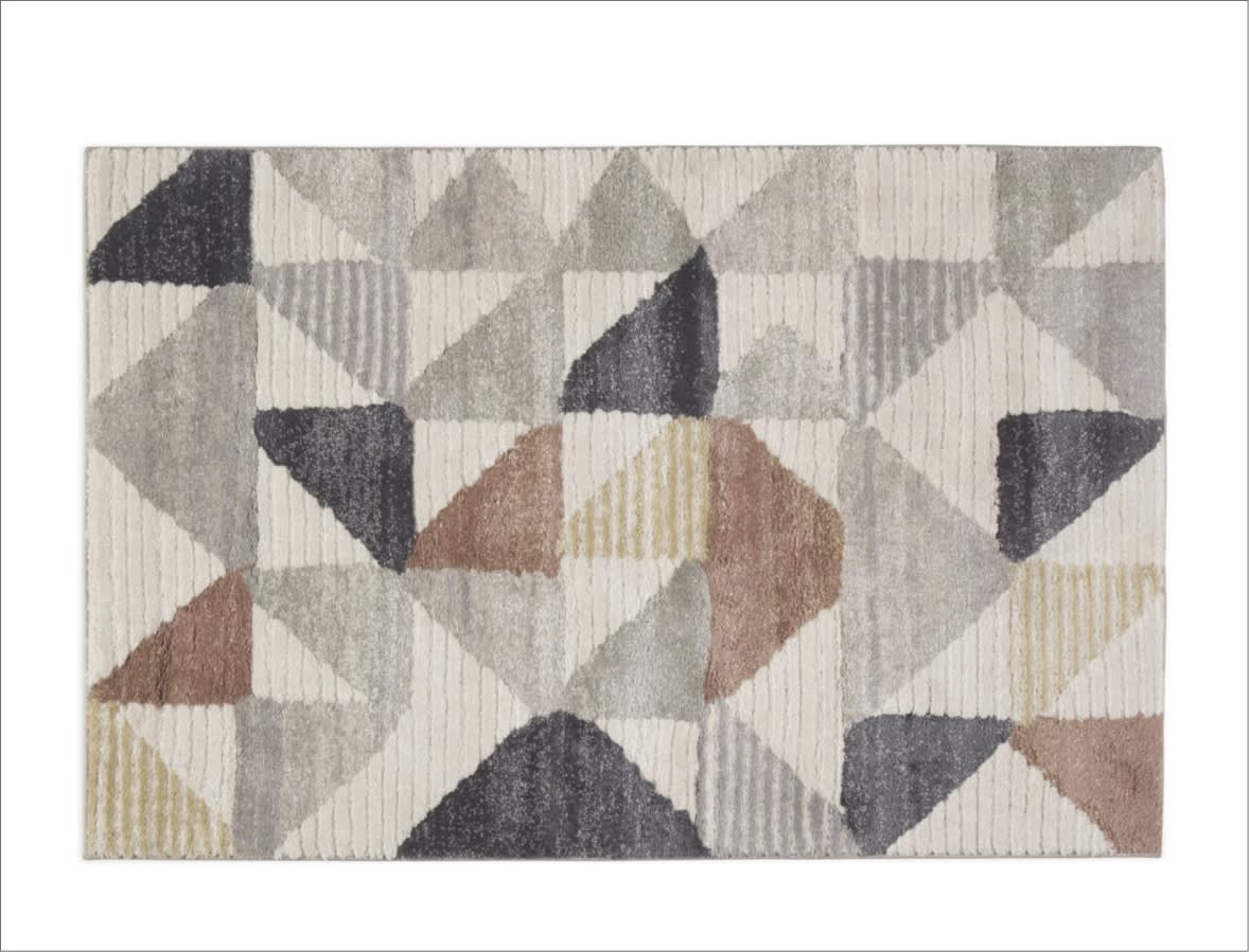 White, beige, and gray geometric triangles area rug.
