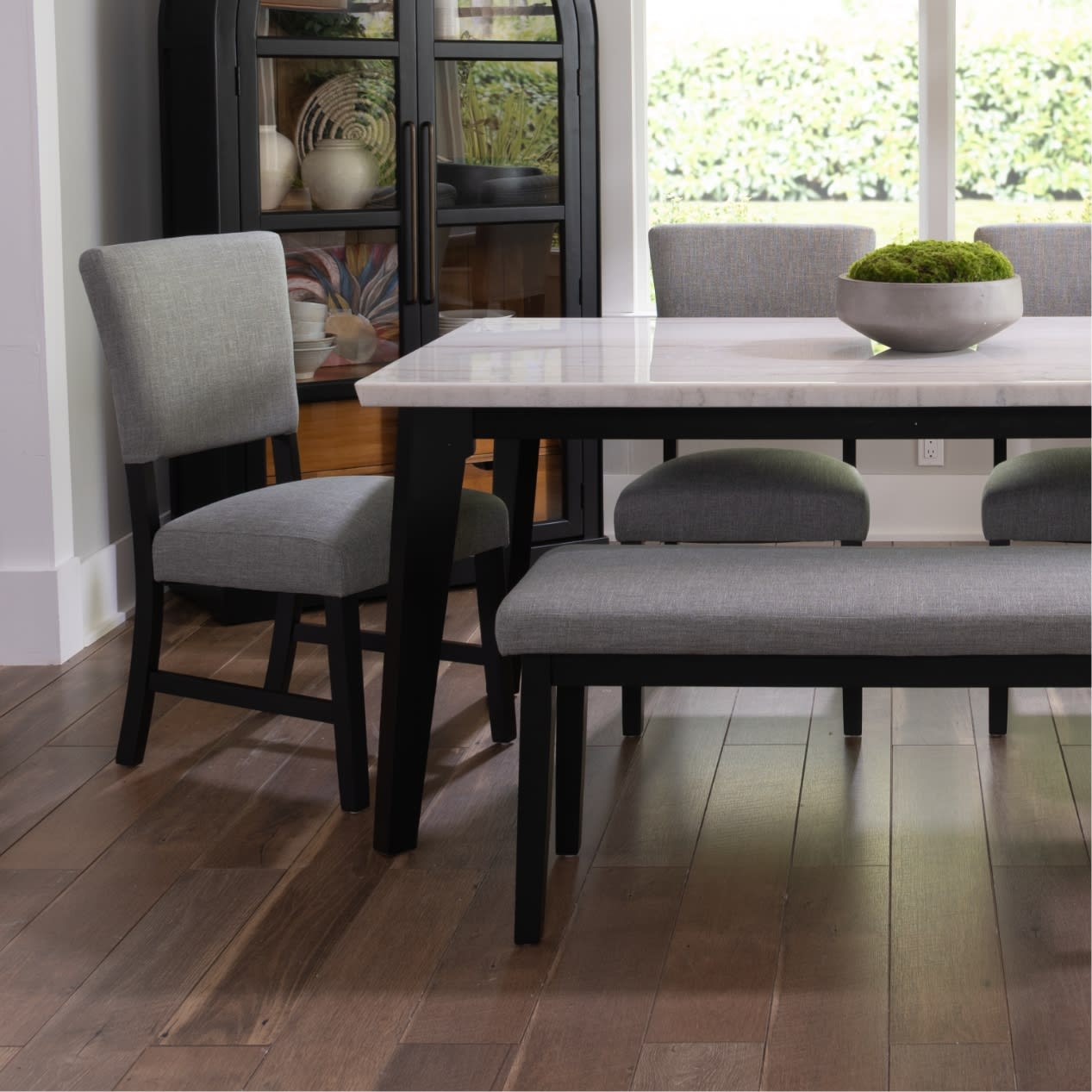 White marble top dining set with gray finish.  Gray and black upholstered dining chairs and bench.