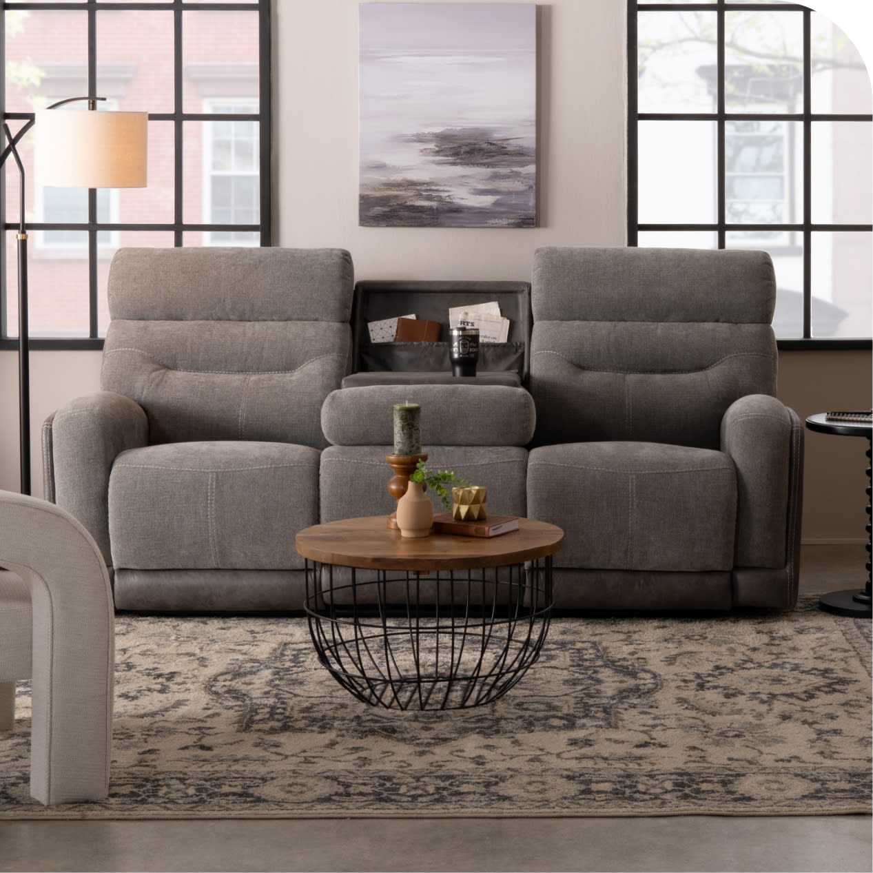 Gray reclining sofa with fold down center table
