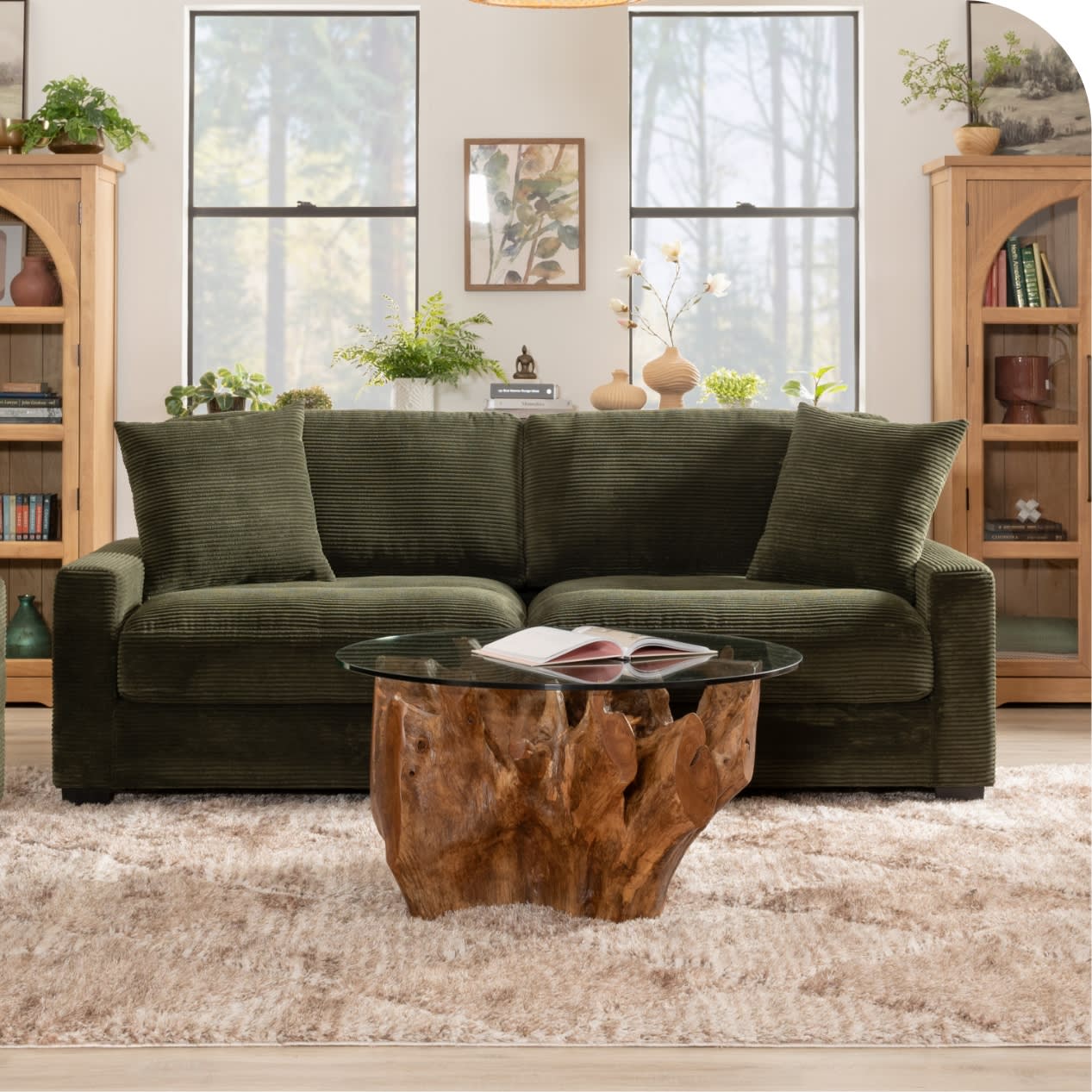 Green sofa with round glass top coffee table.