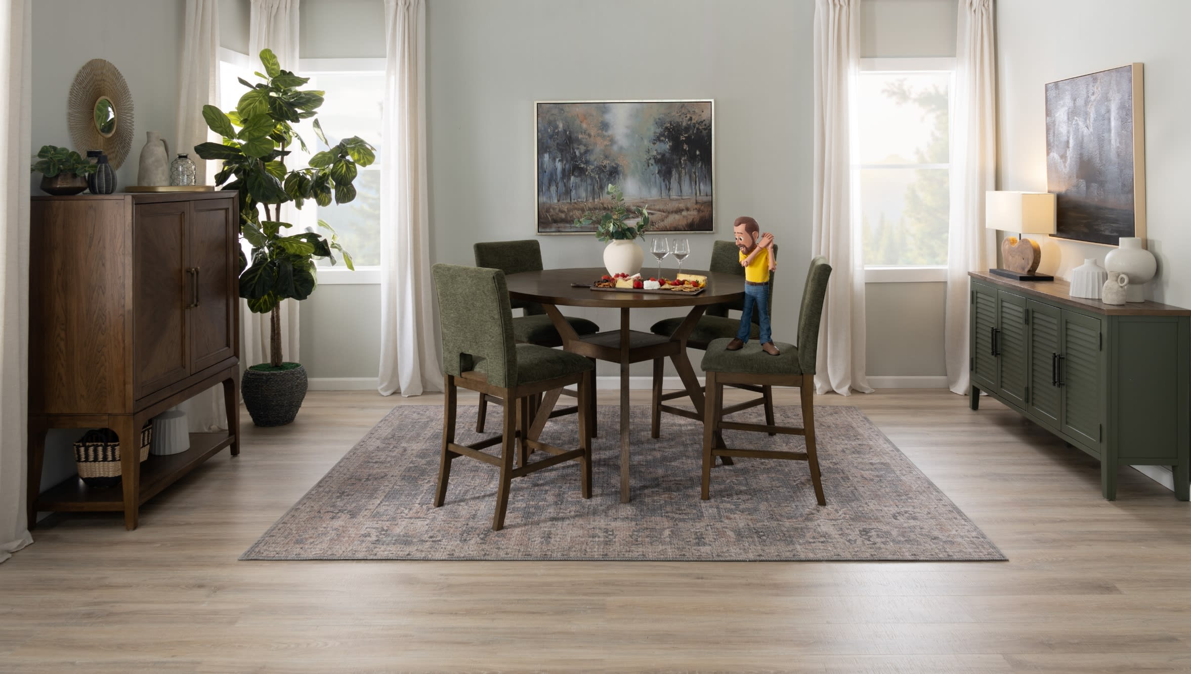 Dining room with a round dark wood table, four olive green upholstered chairs, a patterned area rug, and wooden sideboards with decorative plants and artwork.