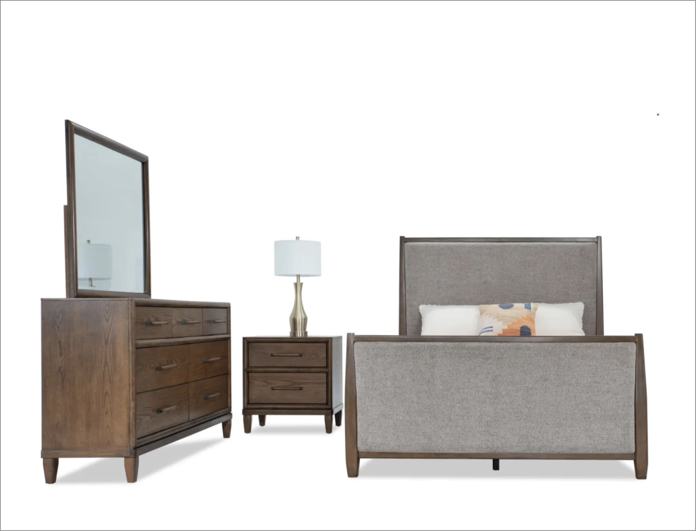 Bedroom set with gray upholstered bed, brown dresser with mirror, and brown nightstand.