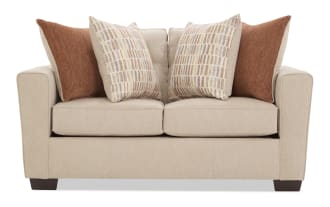 Beige fabric loveseat sofa with dark wooden legs, featuring four decorative throw pillows in rust and patterned beige tones, modern style.