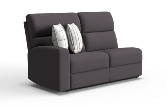 Modern dark gray fabric loveseat with two white decorative pillows, featuring a clean, minimalist design ideal for small living spaces or apartments.