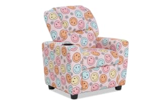 Child-sized upholstered armchair with pastel pink fabric featuring colorful smiley face and flower patterns, cushioned for comfort.