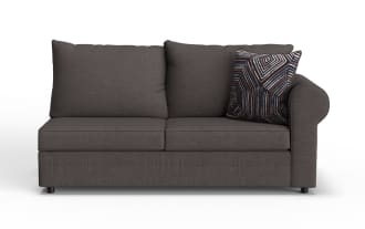 Dark gray fabric loveseat sofa with two large back cushions, one patterned decorative pillow, and rounded armrest on the right side.