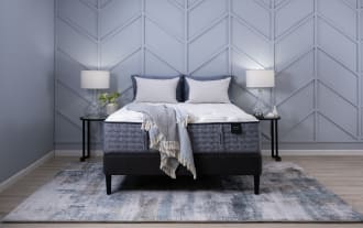Envy 15.5'' King Firm Mattress with hand-tufted Tencel knit cover, gray quilted hybrid layers, gel memory foam, and 2,000 micro coils on black platform bed.