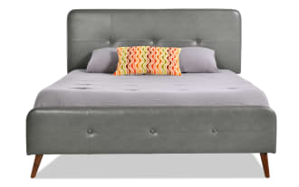 Charcoal gray Bettie Queen platform bed with mid-century modern style, faux leather vinyl upholstery, tufted headboard and footboard, and tapered wooden legs.