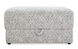 Rectangular storage ottoman upholstered in soft, textured gray fabric with a subtle speckled pattern, featuring a pull tab for easy lid opening.