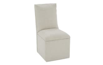 Beige upholstered armless accent chair with cushioned seat and backrest, featuring a textured fabric ideal for modern living spaces.
