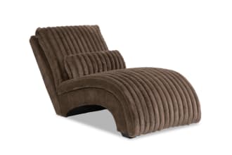 Modern chaise lounge chair upholstered in soft, ribbed brown faux fur fabric with a curved, cushioned design for comfortable seating.