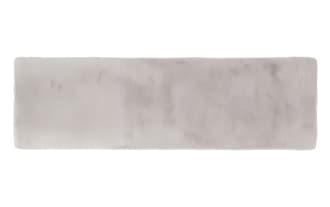 Soft rectangular gray faux fur rug with a smooth, plush texture, ideal for adding warmth and comfort to living spaces.