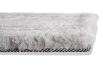Soft, plush light gray area rug with a smooth, even texture, ideal for modern living room or bedroom decor.