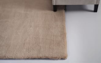 Rectangular beige faux fur rug with a soft, plush texture, ideal for adding warmth and comfort to home interiors.