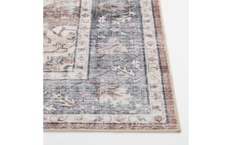 Vintage-style rectangular area rug runner with intricate floral and medallion patterns in muted tones of blue, beige, and rust.