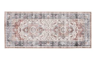 Vintage-style rectangular area rug runner with intricate floral and medallion patterns in muted tones of blue, beige, and rust.