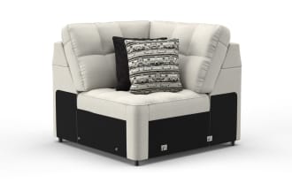 Modern beige fabric sectional sofa corner unit with black base panels, tufted cushions, and two decorative pillows featuring geometric patterns.