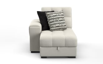 Modern beige fabric chaise lounge with tufted cushions, left armrest, and two decorative pillows in black and patterned gray tones, ideal for living room seating.