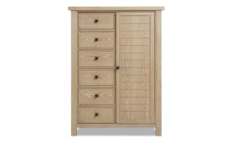 Light wood dresser with six drawers on the left and a vertical cabinet door on the right, featuring black square knobs and a natural oak finish.