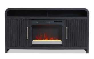 Black wooden electric fireplace TV stand with ribbed cabinet doors, metal handles, open top shelf, and realistic flame effect insert.