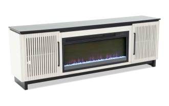 Modern electric fireplace TV stand with white slatted cabinet doors, black metal frame, and realistic LED flame display with blue crystals.