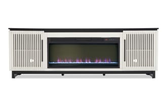 Modern electric fireplace TV stand with white slatted cabinet doors, black metal frame, and realistic LED flame display with blue crystals.
