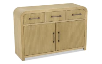 Light wood sideboard with ribbed texture, featuring three top drawers and two large cabinet doors with metal handles, modern design.