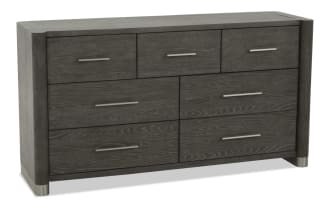 Dark gray wooden dresser with six drawers, sleek silver handles, modern design, and metal-capped legs, suitable for bedroom storage.