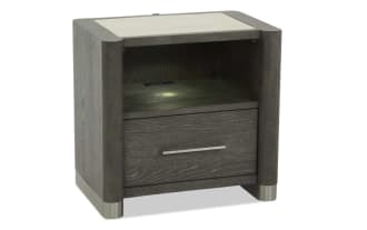 Dark gray wooden nightstand with rounded corners, a single drawer with a horizontal metal handle, open shelf above, and metal feet.