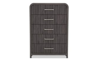 Tall dark gray wooden dresser with five vertically aligned drawers, featuring horizontal silver handles and a textured ribbed front design.