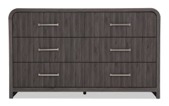 Dark gray wooden dresser with three drawers, vertical groove texture, and sleek metal handles, featuring rounded top corners and modern design.