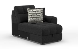 Modern black fabric chaise lounge with tufted seat and backrest, featuring two decorative cushions in black and patterned gray.