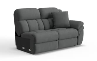 Gray fabric reclining loveseat sofa with padded armrest and back cushions, featuring a matching throw pillow for added comfort.