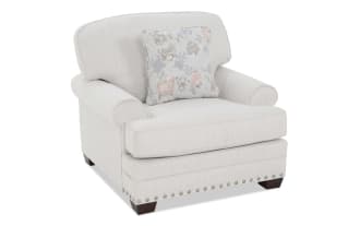 Beige fabric armchair with subtle vertical stripes, rolled arms, wooden legs, and a floral-patterned accent pillow, ideal for living room seating.
