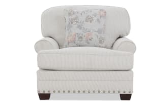 Beige fabric armchair with subtle vertical stripes, rolled arms, wooden legs, and a floral-patterned accent pillow, ideal for living room seating.